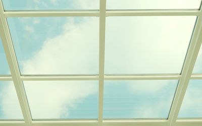 Clear morning sky visible through a modern window